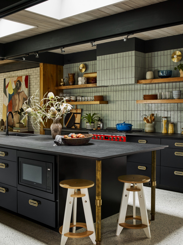 Design ideas for a large midcentury galley open plan kitchen in Atlanta with an undermount sink, black cabinets, green splashback, brick splashback, with island, multi-coloured floor and grey benchtop.