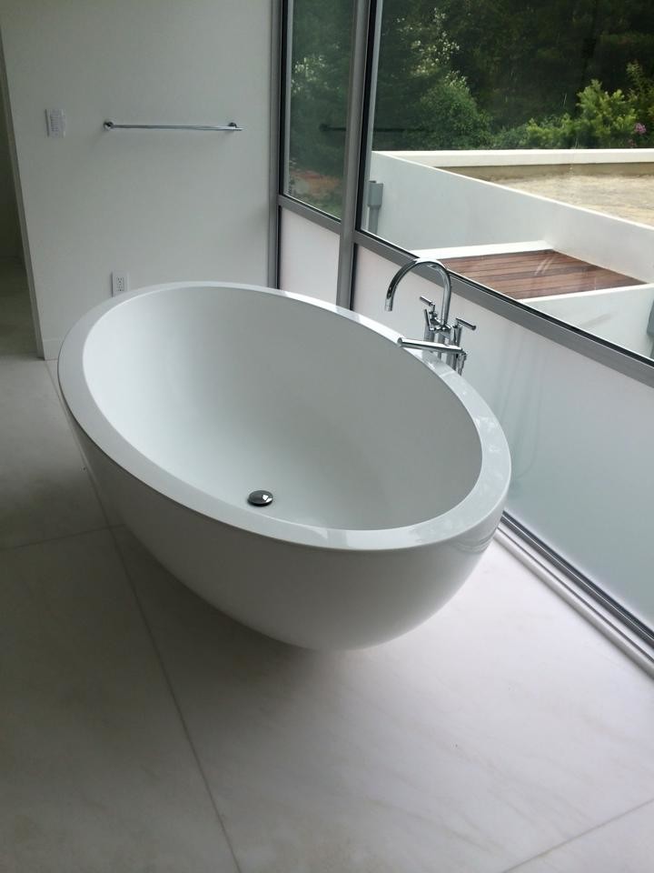 Inspiration for a large modern master bathroom in San Francisco with flat-panel cabinets, white cabinets, a freestanding tub, an open shower, white walls, marble floors, an undermount sink, quartzite benchtops, white floor, a hinged shower door and white benchtops.