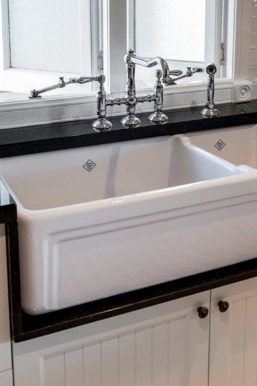 Design ideas for a mid-sized traditional u-shaped eat-in kitchen in Brisbane with a farmhouse sink, recessed-panel cabinets, white cabinets, granite benchtops, white splashback, subway tile splashback, stainless steel appliances, ceramic floors and with island.