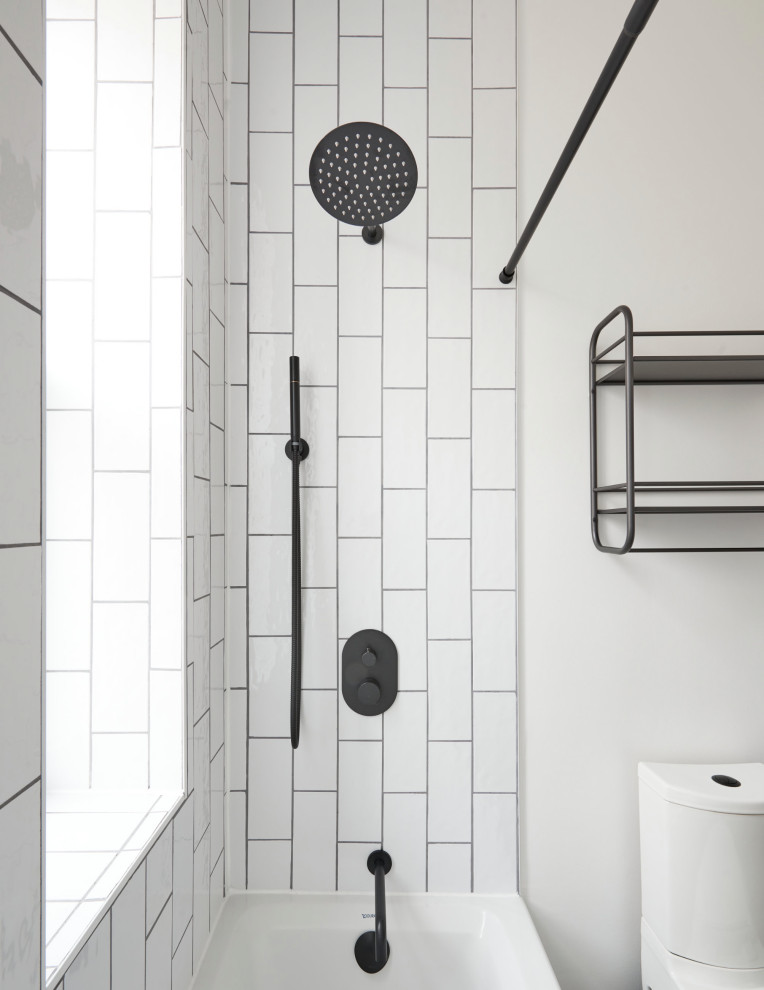 Design ideas for a small transitional master bathroom in Chicago with flat-panel cabinets, brown cabinets, an alcove tub, a shower/bathtub combo, a two-piece toilet, white tile, white walls, porcelain floors, black floor, white benchtops, a single vanity and a floating vanity.