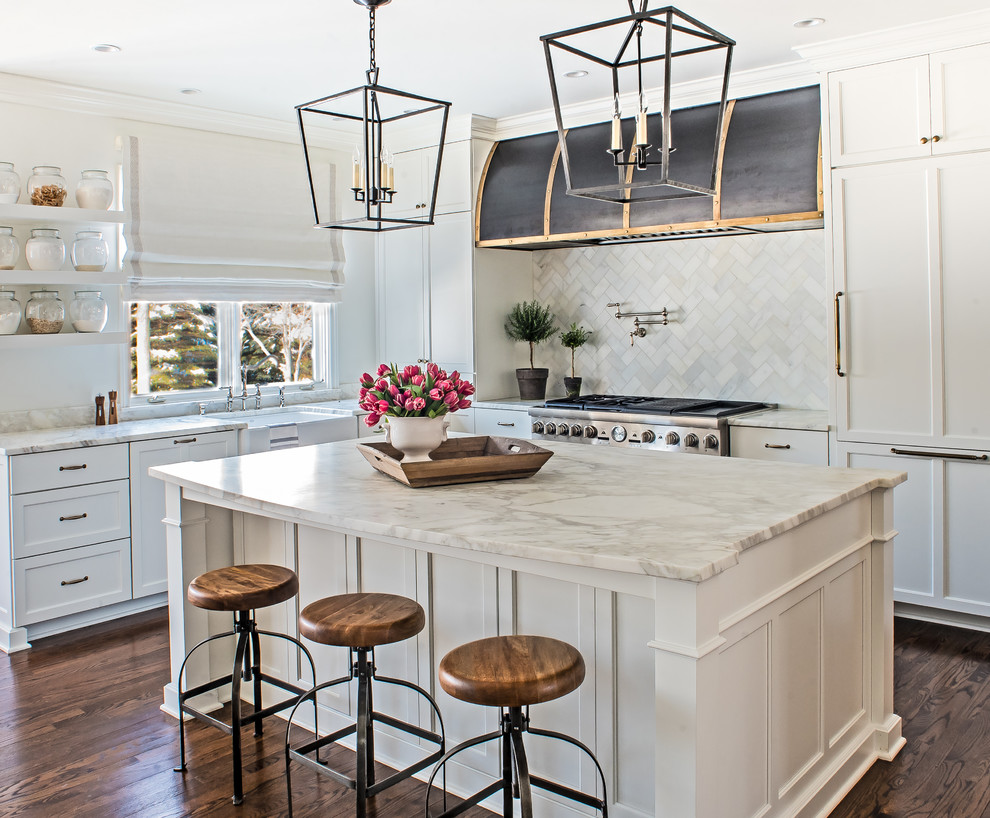 Large traditional u-shaped eat-in kitchen in Detroit with a farmhouse sink, flat-panel cabinets, white cabinets, marble benchtops, white splashback, marble splashback, stainless steel appliances, dark hardwood floors and with island.