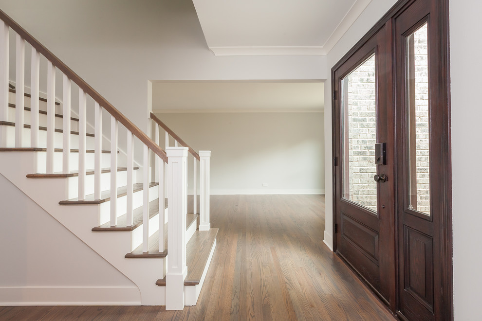 Design ideas for a transitional wood l-shaped staircase in Chicago with painted wood risers and wood railing.