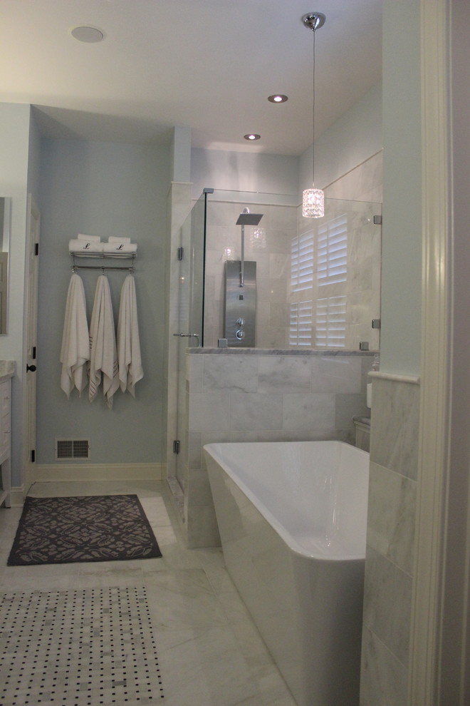 Inspiration for an expansive traditional master bathroom in Baltimore with recessed-panel cabinets, white cabinets, marble benchtops, a freestanding tub, a corner shower, white tile, ceramic tile, blue walls and ceramic floors.