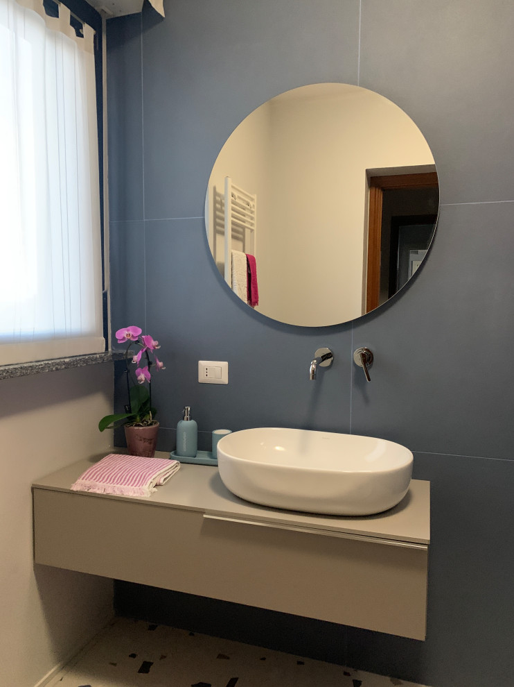 Photo of a medium sized contemporary shower room bathroom in Milan with beaded cabinets, beige cabinets, a built-in shower, a one-piece toilet, blue tiles, porcelain tiles, blue walls, porcelain flooring, a vessel sink, wooden worktops, blue floors, an open shower, beige worktops, a single sink and a floating vanity unit.