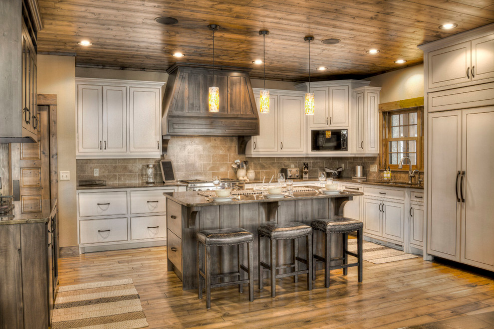 Design ideas for a country l-shaped kitchen in Minneapolis with an undermount sink, beaded inset cabinets, beige cabinets, beige splashback, panelled appliances, medium hardwood floors, with island and orange floor.