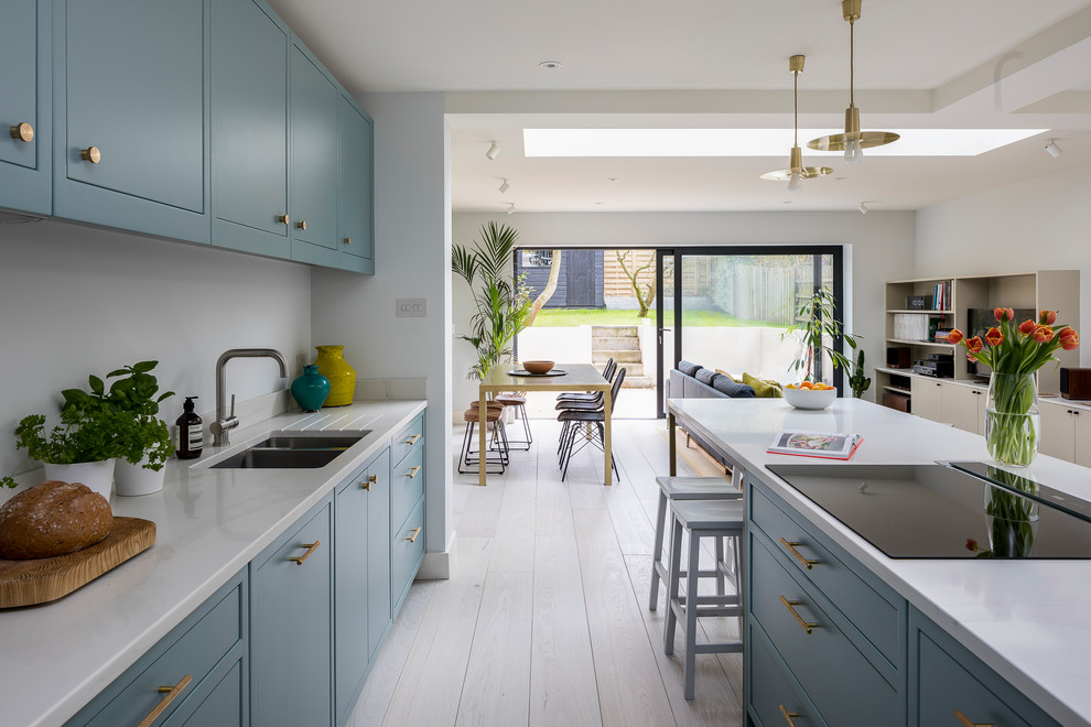 Design ideas for a contemporary open plan kitchen in London with with island.