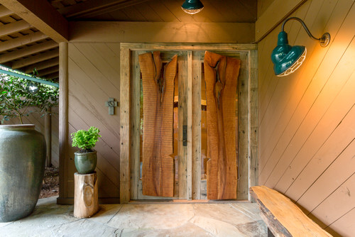 Mountain style entryway photo in Seattle with brown walls and a rustic wood front door.