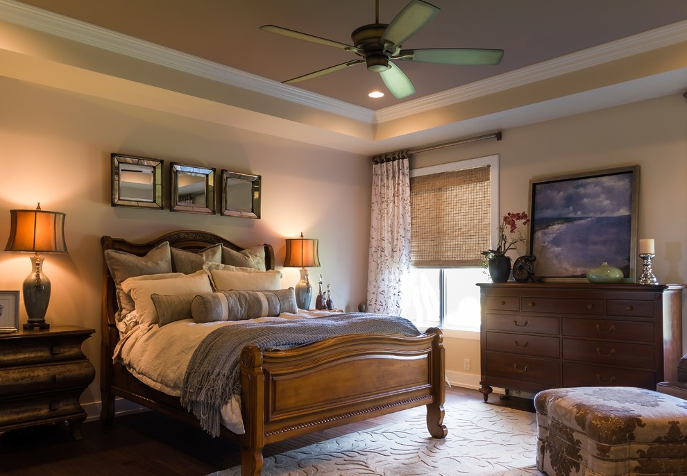 Photo of a large traditional master bedroom in Omaha with beige walls, dark hardwood floors and no fireplace.