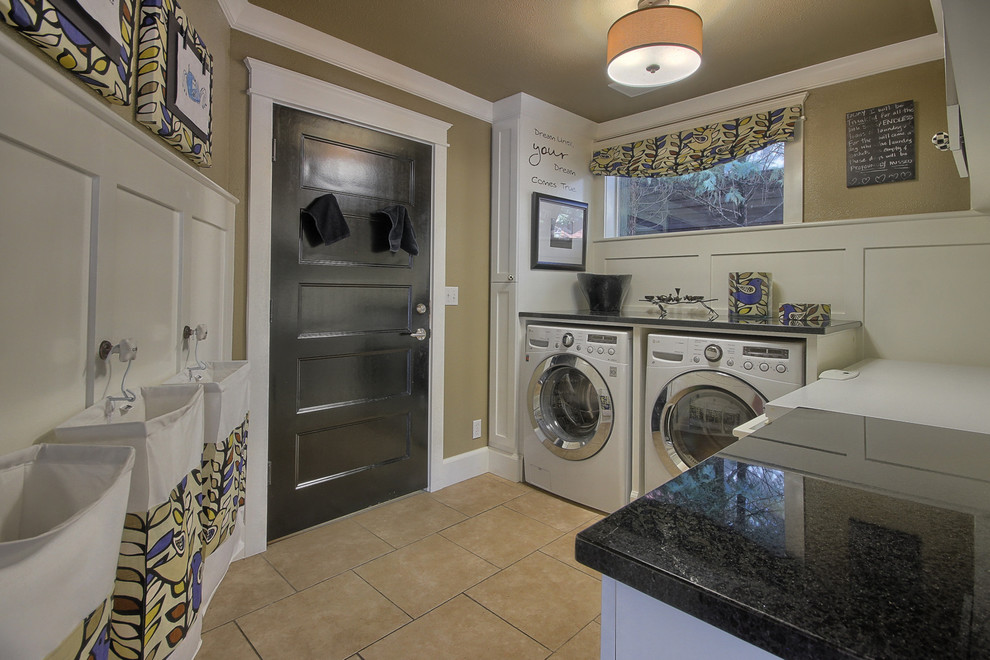 Photo of a mid-sized transitional l-shaped utility room in Other with shaker cabinets, white cabinets, granite benchtops, brown walls, porcelain floors and a side-by-side washer and dryer.