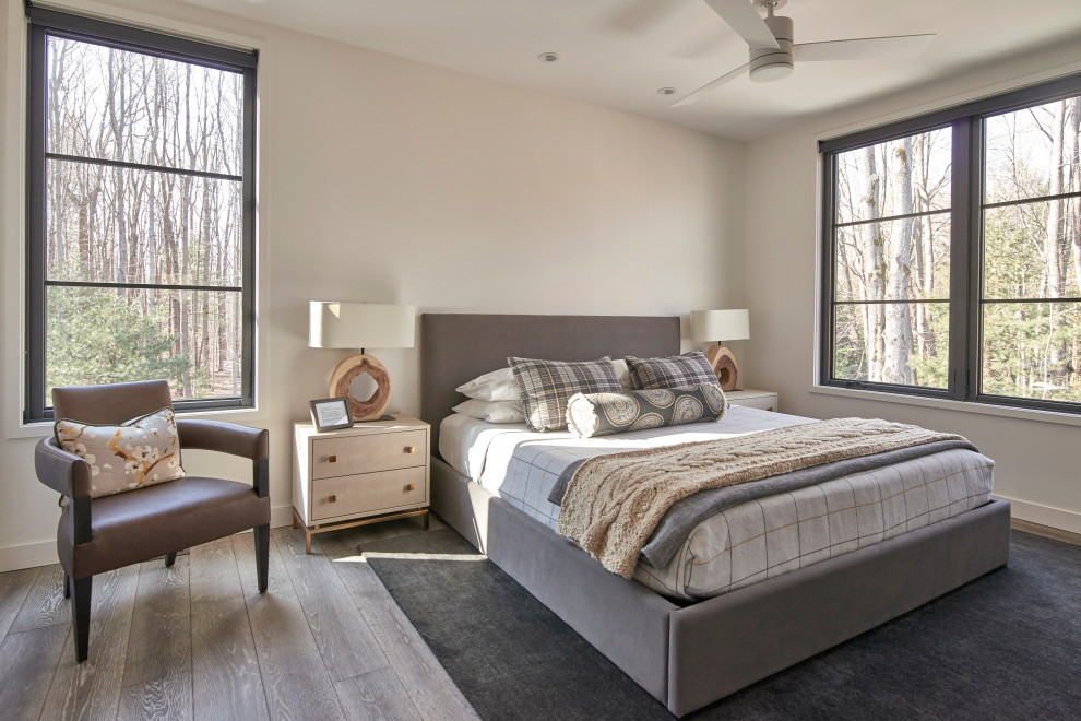 Mid-sized country guest bedroom in Chicago with white walls, light hardwood floors and grey floor.
