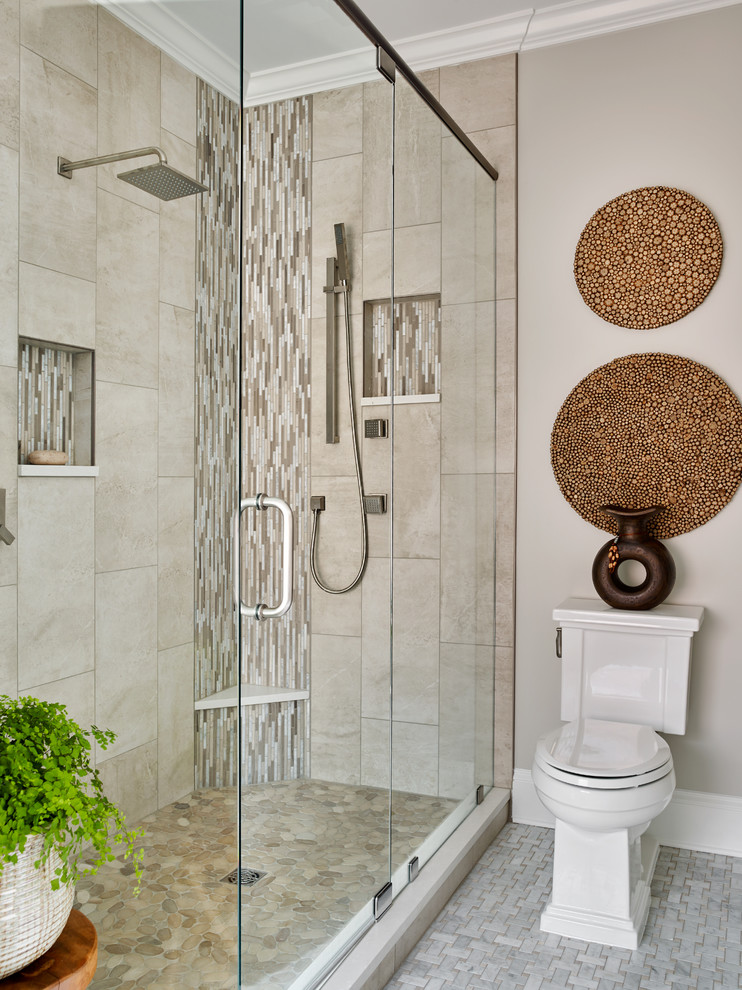 Inspiration for a mid-sized transitional master bathroom in Atlanta with raised-panel cabinets, medium wood cabinets, a freestanding tub, a corner shower, a one-piece toilet, gray tile, mosaic tile, grey walls, marble floors, an undermount sink and engineered quartz benchtops.