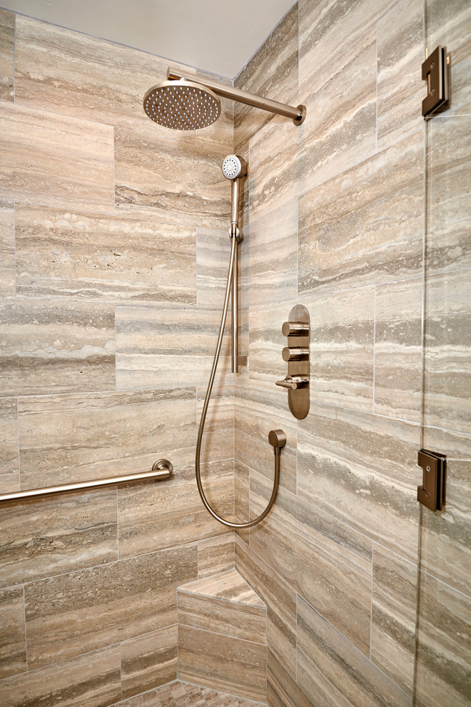 Inspiration for a medium sized traditional ensuite bathroom in Denver with recessed-panel cabinets, beige cabinets, a walk-in shower, beige tiles, limestone tiles, beige walls, limestone flooring, a submerged sink, quartz worktops, beige floors and a hinged door.