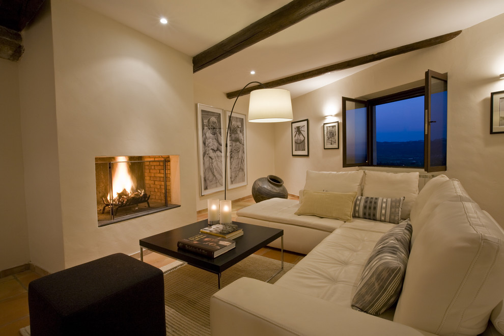Design ideas for a mediterranean living room in Marseille with beige walls and a standard fireplace.