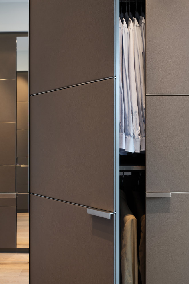 Design ideas for an expansive contemporary built-in wardrobe in Cologne with beaded inset cabinets and brown cabinets.