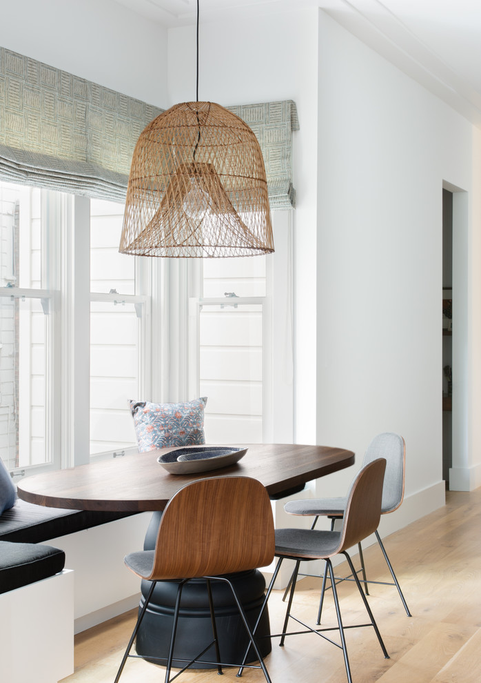 Pacific Heights Collected Contemporary - Intentional. Elevated. Artisanal.
 
With three children under the age of 5, our clients were starting to feel the confines of their Pacific Heights home when the expansive 1902 Italianate across the street went on the market. After learning the home had been recently remodeled, they jumped at the chance to purchase a move-in ready property. We worked with them to infuse the already refined, elegant living areas with subtle edginess and handcrafted details, and also helped them reimagine unused space to delight their little ones.
 
Elevated furnishings on the main floor complement the home’s existing high ceilings, modern brass bannisters and extensive walnut cabinetry. In the living room, sumptuous emerald upholstery on a velvet side chair balances the deep wood tones of the existing baby grand. Minimally and intentionally accessorized, the room feels formal but still retains a sharp edge—on the walls moody portraiture gets irreverent with a bold paint stroke, and on the the etagere, jagged crystals and metallic sculpture feel rugged and unapologetic. Throughout the main floor handcrafted, textured notes are everywhere—a nubby jute rug underlies inviting sofas in the family room and a half-moon mirror in the living room mixes geometric lines with flax-colored fringe. 
 
On the home’s lower level, we repurposed an unused wine cellar into a well-stocked craft room, with a custom chalkboard, art-display area and thoughtful storage. In the adjoining space, we installed a custom climbing wall and filled the balance of the room with low sofas, plush area rugs, poufs and storage baskets, creating the perfect space for active play or a quiet reading session. The bold colors and playful attitudes apparent in these spaces are echoed upstairs in each of the children’s imaginative bedrooms.
 
Architect + Developer: McMahon Architects + Studio, Photographer: Suzanna Scott Photography