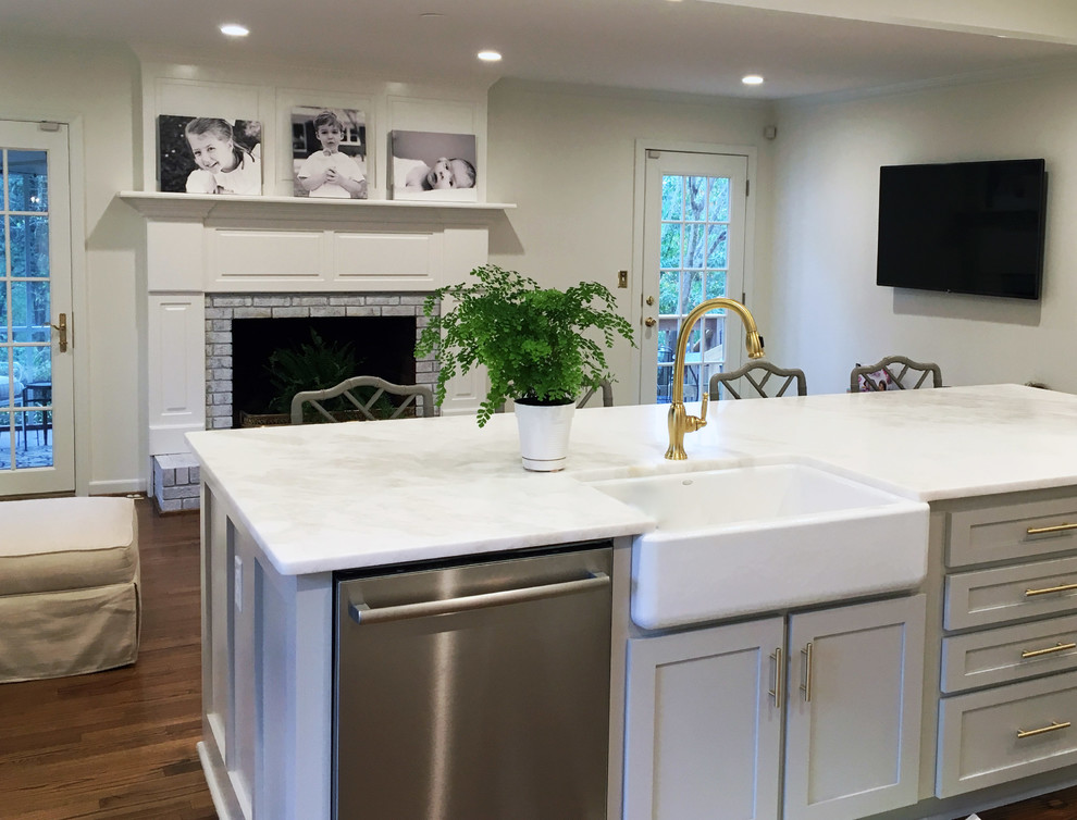 Kitchen - transitional medium tone wood floor kitchen idea with a farmhouse sink and stainless steel appliances