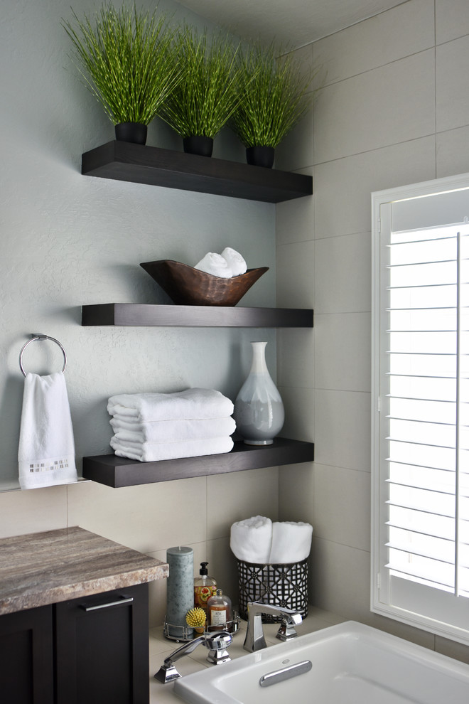 Inspiration for a mid-sized transitional master white tile drop-in bathtub remodel in Phoenix with shaker cabinets, dark wood cabinets, a one-piece toilet, blue walls, an undermount sink and a hinged shower door