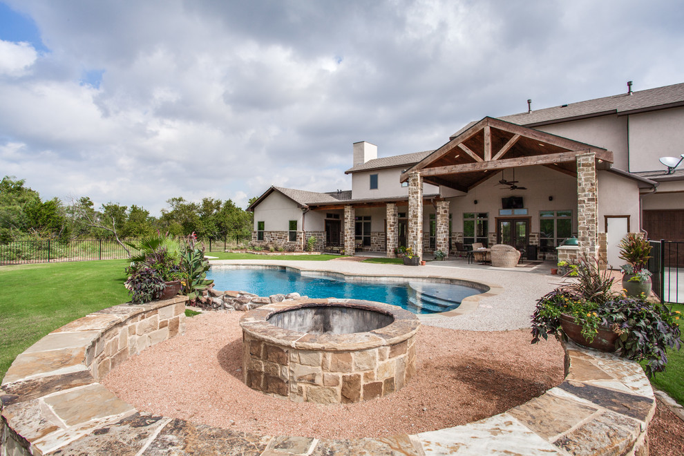 Photo of an expansive country two-storey beige exterior in Dallas with stone veneer.