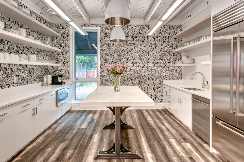 Inspiration for a transitional galley medium tone wood floor kitchen remodel in Seattle with an undermount sink, flat-panel cabinets, white cabinets, quartz countertops and stainless steel appliances