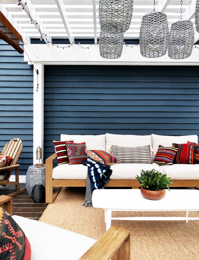 Design ideas for an expansive eclectic backyard deck in New York with a pergola.