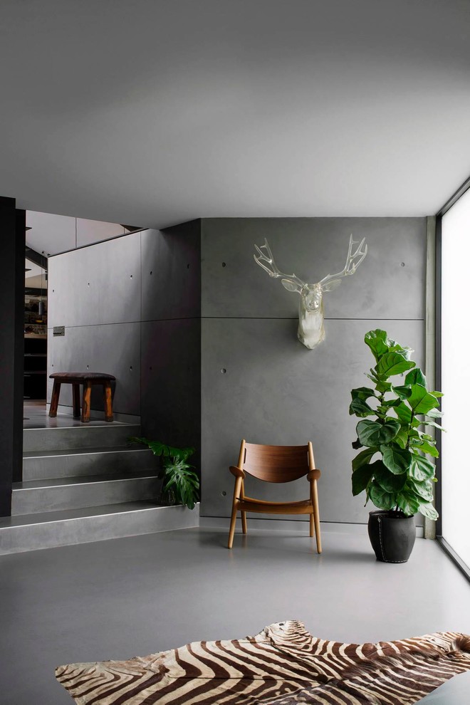 Design ideas for a mid-sized industrial foyer in Sydney with grey walls.