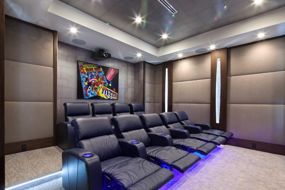 Mid-sized modern enclosed home theatre in Miami with beige walls, carpet and a projector screen.