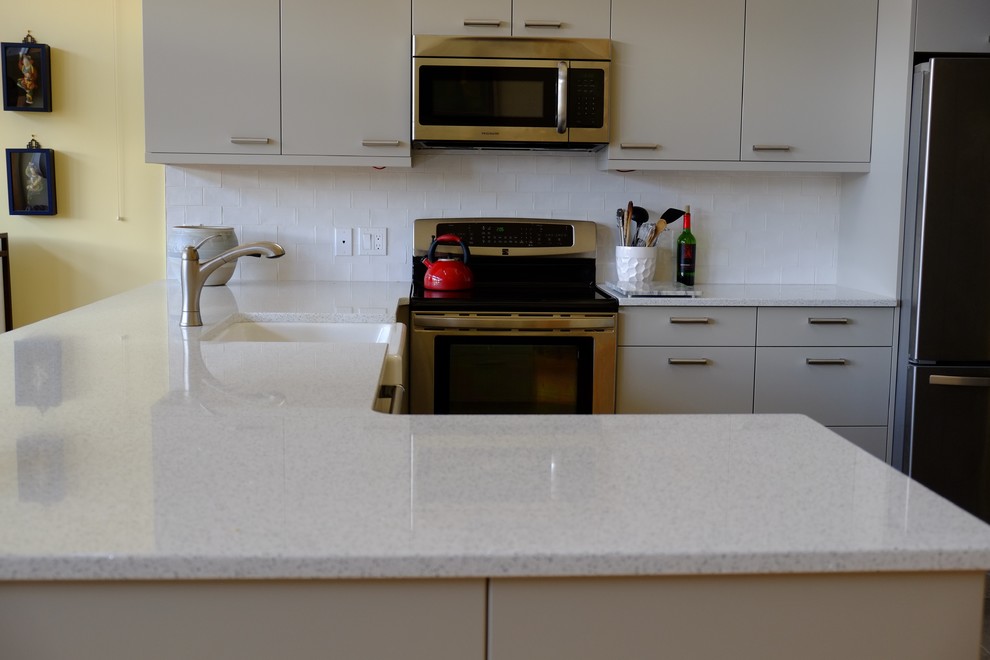 Example of a transitional kitchen design in Calgary