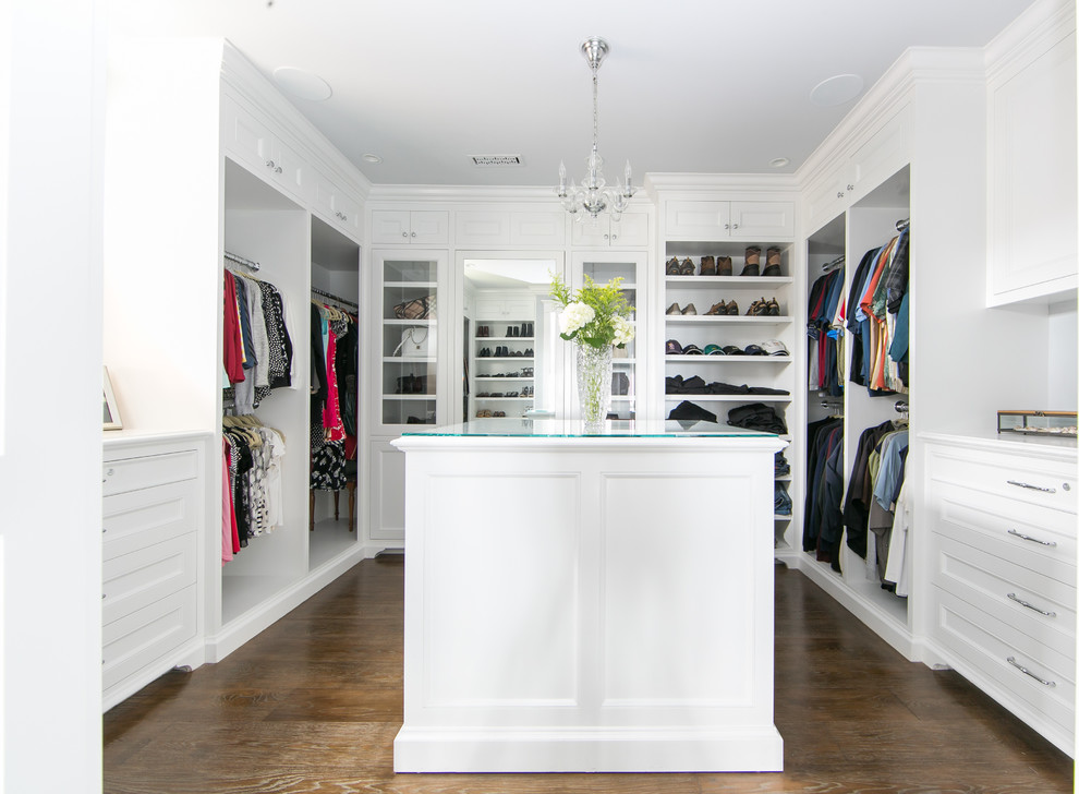 Example of a transitional gender-neutral medium tone wood floor and brown floor dressing room design in Orange County with white cabinets and recessed-panel cabinets