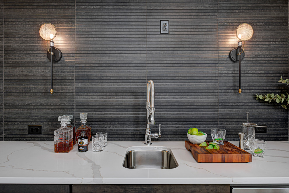 Inspiration for a mid-sized country single-wall wet bar in Indianapolis with an undermount sink, shaker cabinets, distressed cabinets, quartz benchtops, grey splashback, stone tile splashback and white benchtop.