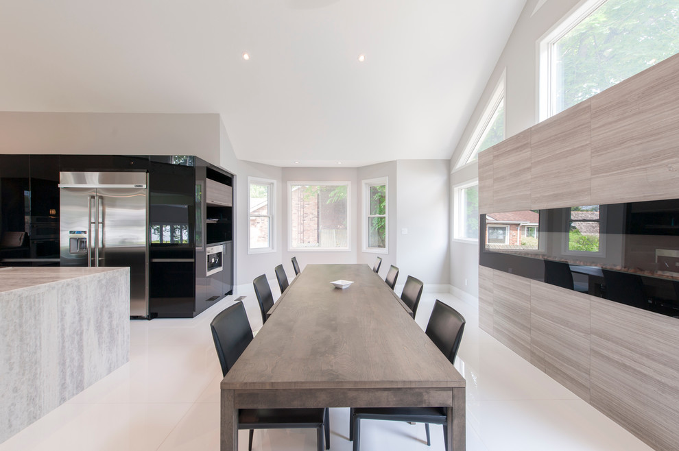 Inspiration for an expansive contemporary kitchen/dining combo in Toronto with grey walls, ceramic floors, a ribbon fireplace and a tile fireplace surround.