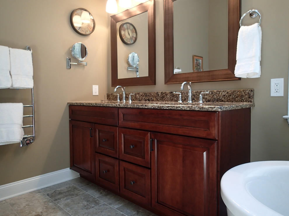 Mid-sized transitional master bathroom in Philadelphia with an undermount sink, shaker cabinets, dark wood cabinets, engineered quartz benchtops, a freestanding tub, a corner shower, a two-piece toilet, gray tile, porcelain tile, brown walls and porcelain floors.