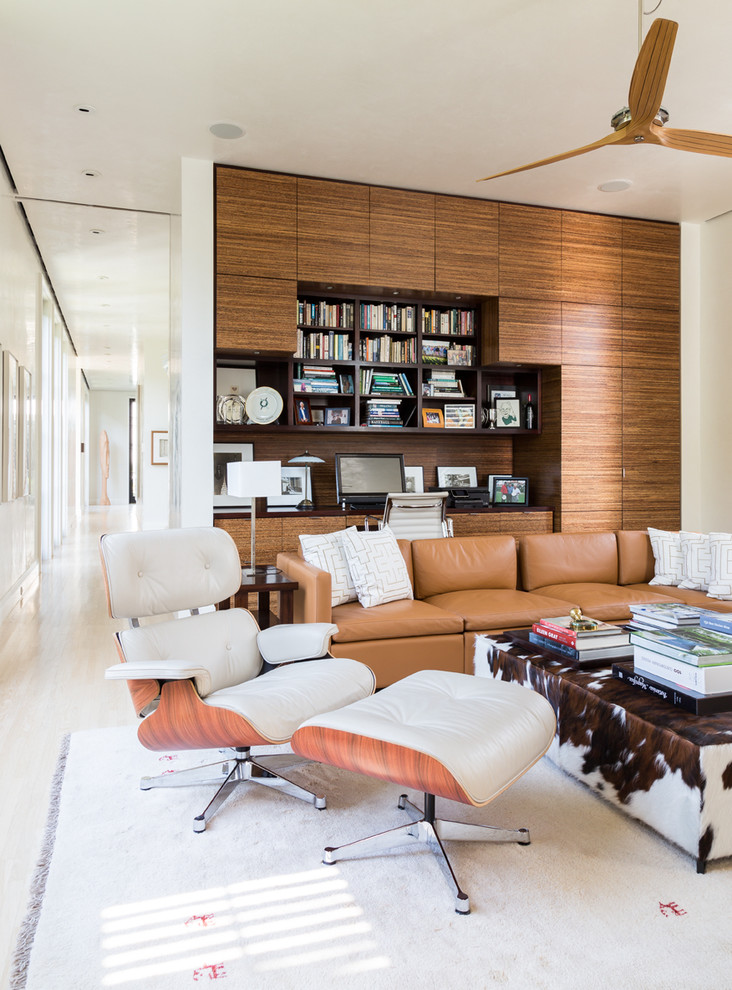 Inspiration for a mid-sized midcentury enclosed living room in Miami with a library, white walls, porcelain floors, no fireplace, no tv and white floor.