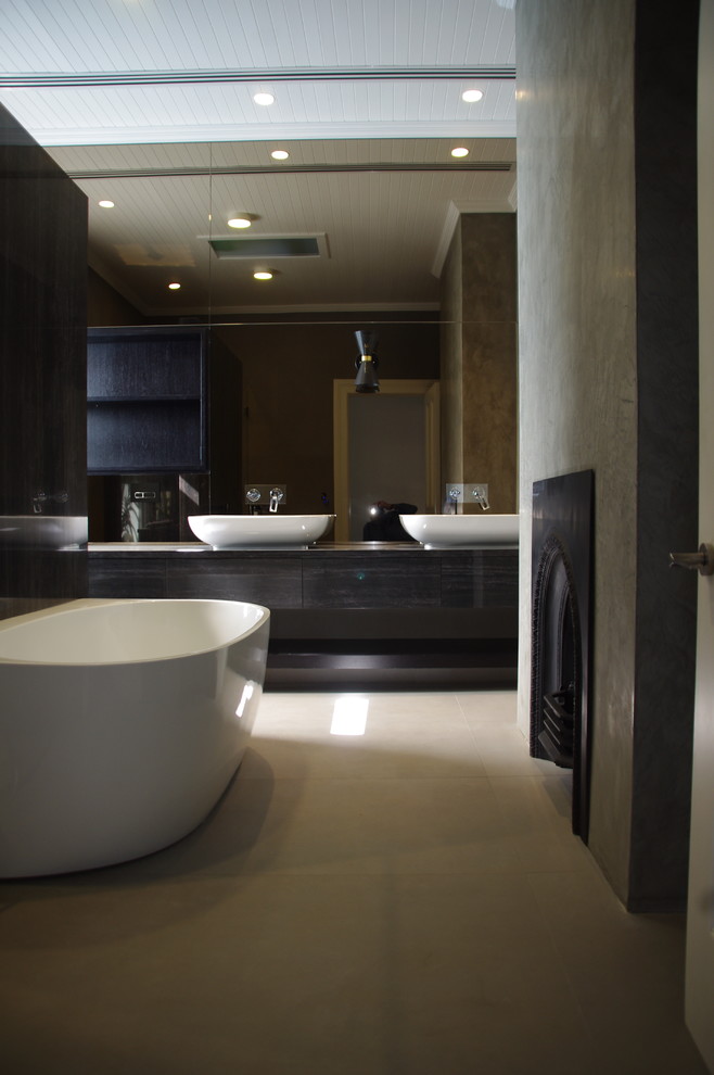 Inspiration for a mid-sized contemporary master bathroom in Sydney with open cabinets, black cabinets, a freestanding tub, an alcove shower, gray tile, grey walls, limestone floors, marble benchtops, stone tile and a vessel sink.