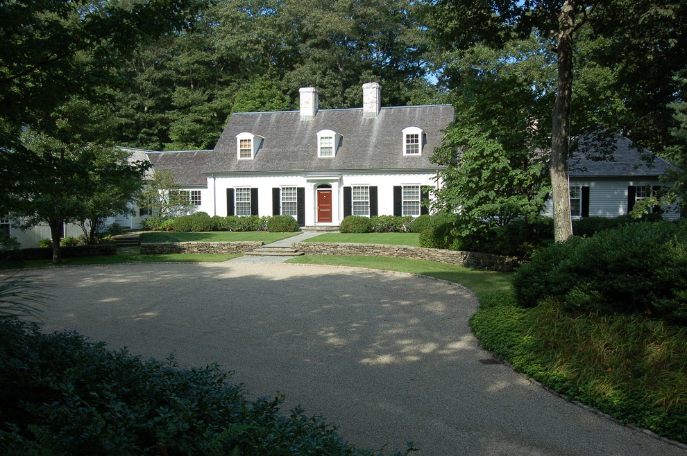 Photo of an expansive traditional two-storey white exterior in Boston with vinyl siding and a gable roof.