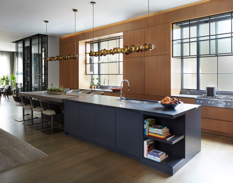 Photo of a contemporary galley open plan kitchen in Chicago with an undermount sink, flat-panel cabinets, medium wood cabinets, dark hardwood floors, with island and brown floor.