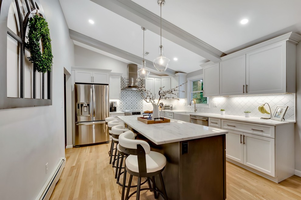 Eat-in kitchen - transitional light wood floor eat-in kitchen idea in Boston with an island