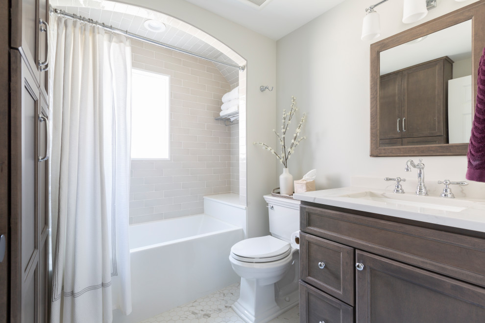 Inspiration for a small traditional master bathroom in New York with recessed-panel cabinets, brown cabinets, a drop-in tub, a shower/bathtub combo, a two-piece toilet, mosaic tile floors, an undermount sink, engineered quartz benchtops, white floor, a shower curtain, white benchtops, a niche, a single vanity and a built-in vanity.