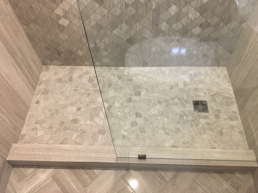 Mid-sized modern 3/4 bathroom in Austin with an alcove shower, gray tile, limestone, grey walls and pebble tile floors.