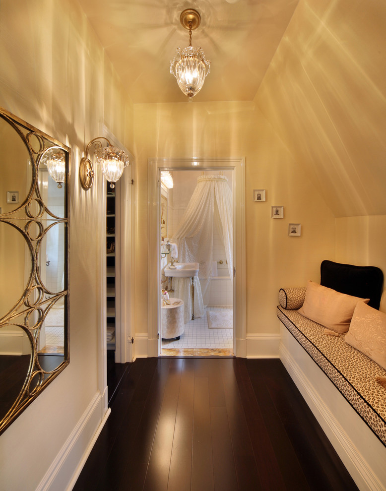 This is an example of a mid-sized contemporary hallway in New York with dark hardwood floors and yellow walls.