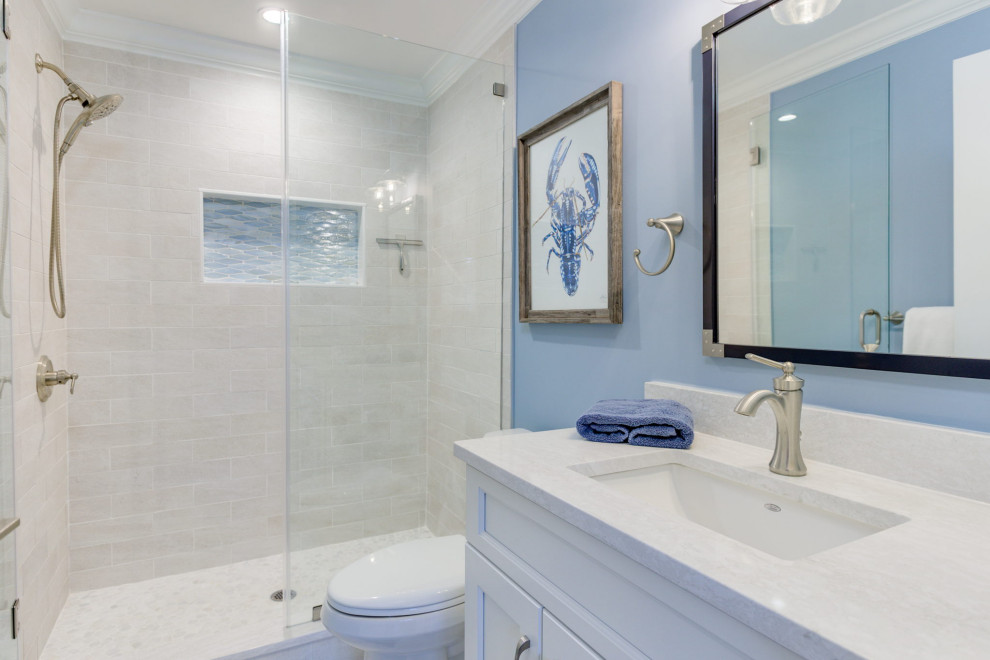 Inspiration for a large coastal bathroom in Philadelphia with recessed-panel cabinets, white cabinets, a freestanding bath, an alcove shower, blue walls, marble flooring, a submerged sink, quartz worktops, white floors, a sliding door, white worktops, double sinks and a built in vanity unit.