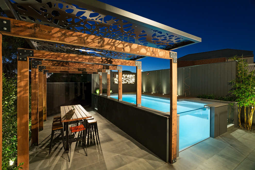 This is an example of a mid-sized contemporary backyard rectangular pool in Melbourne.