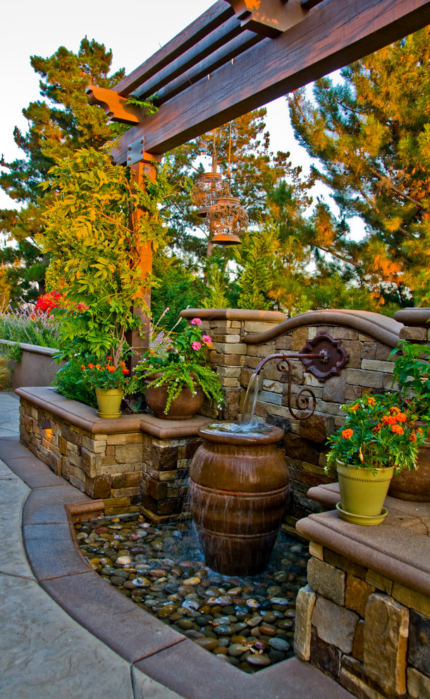 Mediterranean garden in Orange County with a water feature.