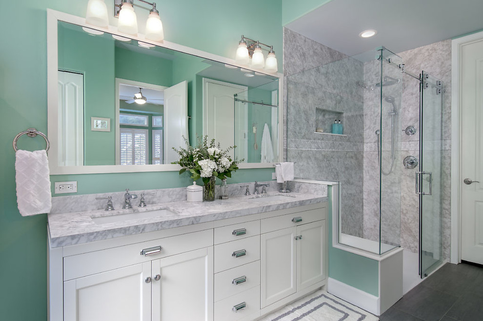 Large beach style master bathroom in Seattle with recessed-panel cabinets, white cabinets, a freestanding tub, a corner shower, green walls, vinyl floors, an undermount sink, marble benchtops, grey floor, a sliding shower screen and grey benchtops.