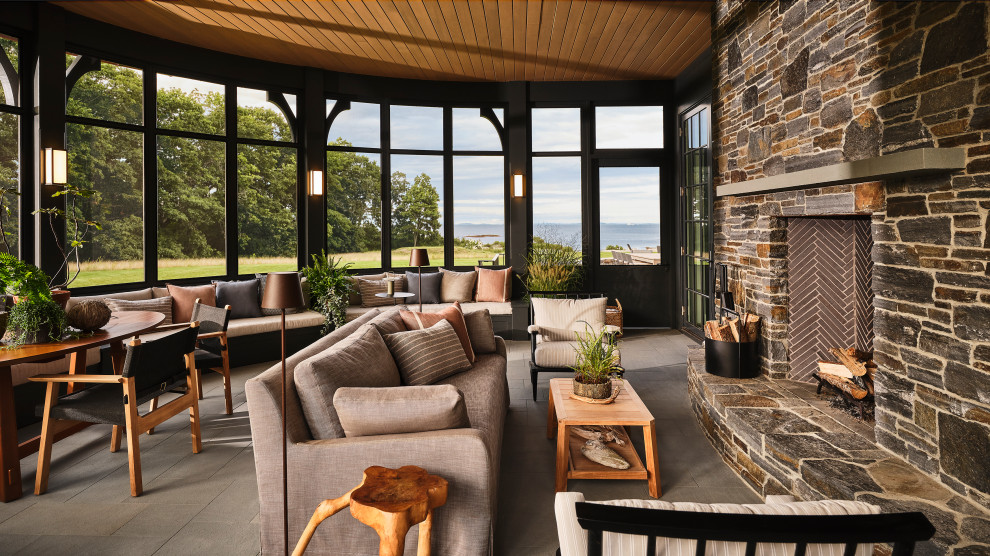 Transitional screened-in side porch photo in Portland Maine with a roof extension