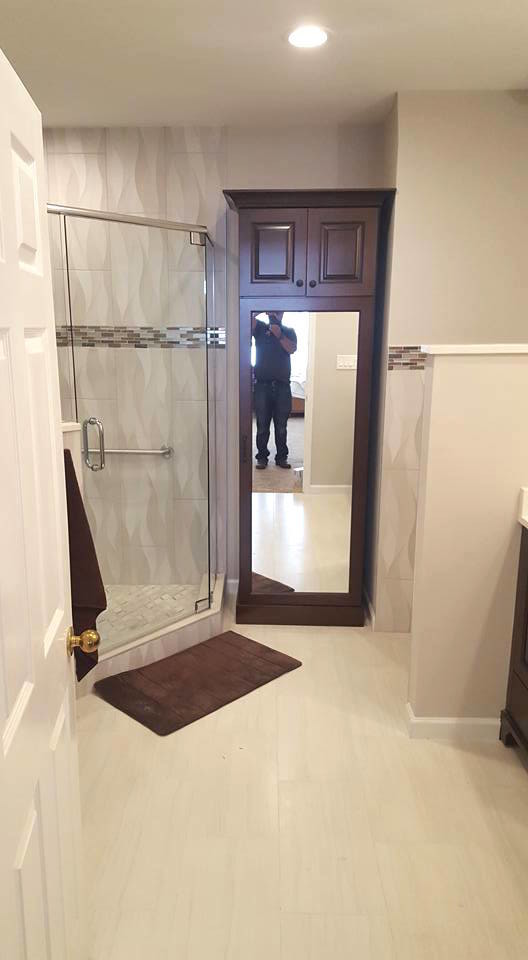 Corner shower - large transitional master beige floor corner shower idea in Miami with furniture-like cabinets, dark wood cabinets, beige walls, a hinged shower door, a one-piece toilet and an undermount sink