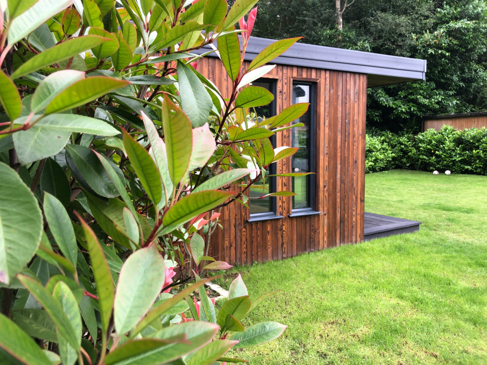 Example of a mid-sized trendy detached studio / workshop shed design in Surrey