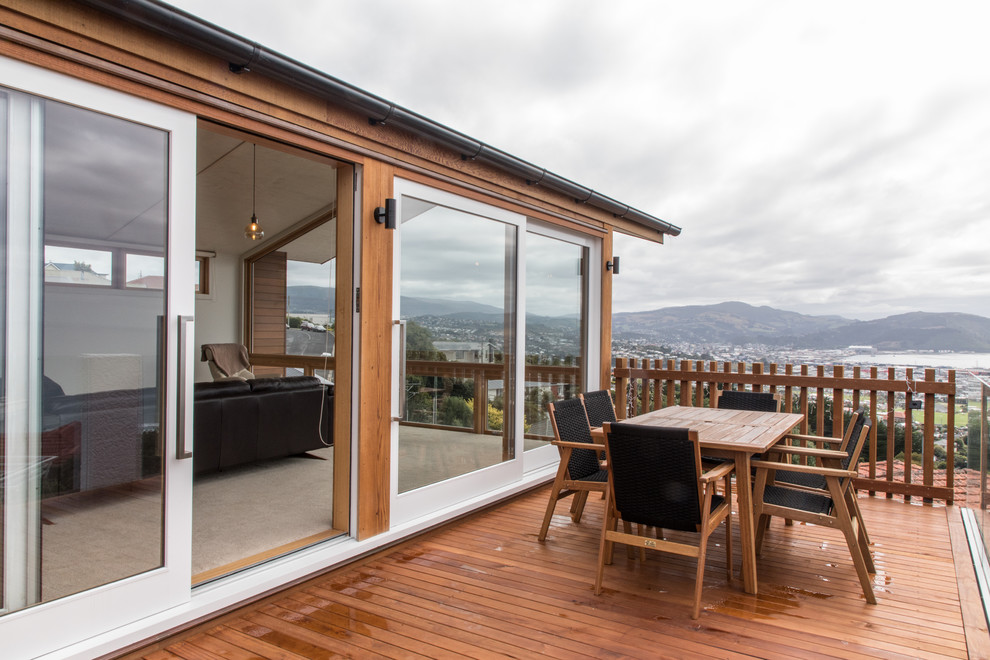 Design ideas for a large contemporary balcony in Dunedin with no cover and glass railing.