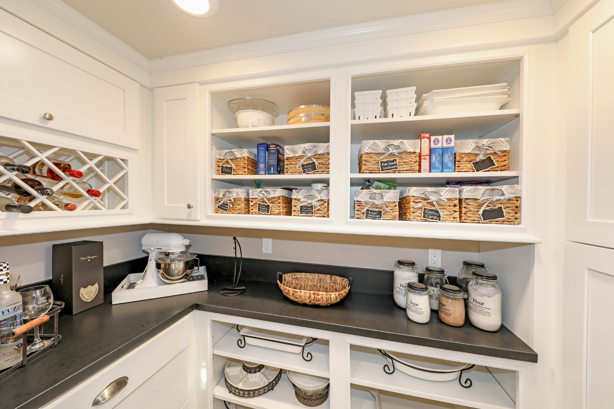 Inspiration for a small transitional l-shaped kitchen pantry remodel in Orange County with shaker cabinets and white cabinets
