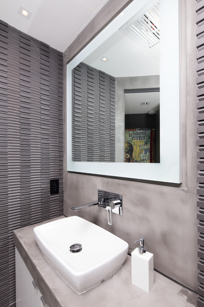 This is an example of a small contemporary 3/4 bathroom in Miami with flat-panel cabinets, light wood cabinets, concrete benchtops, a corner shower, a wall-mount toilet, black tile and cement tile.