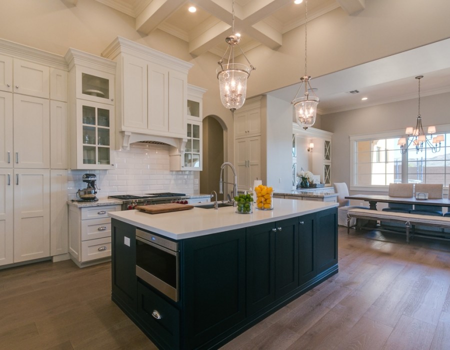 Inspiration for a large transitional l-shaped dark wood floor and brown floor open concept kitchen remodel in Phoenix with an undermount sink, shaker cabinets, white cabinets, quartz countertops, white backsplash, subway tile backsplash, stainless steel appliances and two islands